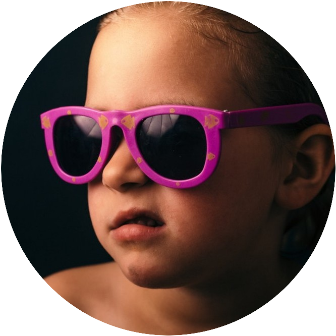 Child with pink glasses on